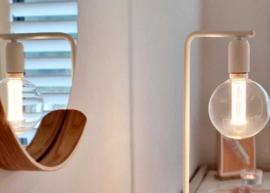 Modern lamp reflecting in a mirror at Room of Beauty, Papamoa, Bay Of Plenty, NZ.