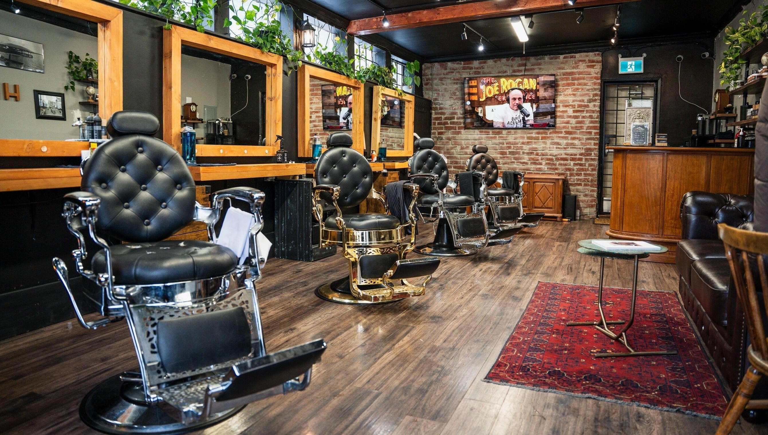 Interior of HEstory Barbershop in Vancouver, BC, showcasing vintage barber chairs and rustic decor.