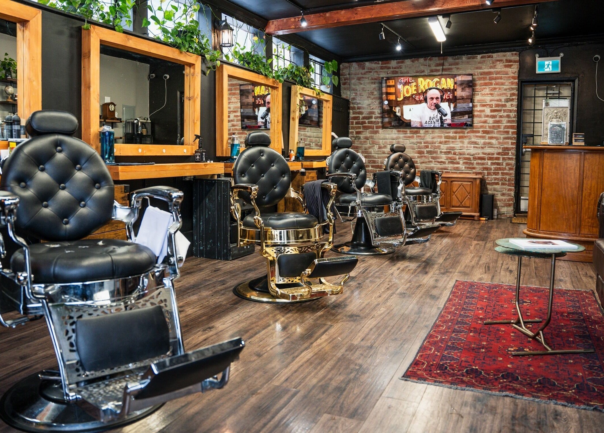 Interior of HEstory Barbershop in Vancouver, BC, showcasing vintage barber chairs and rustic decor.
