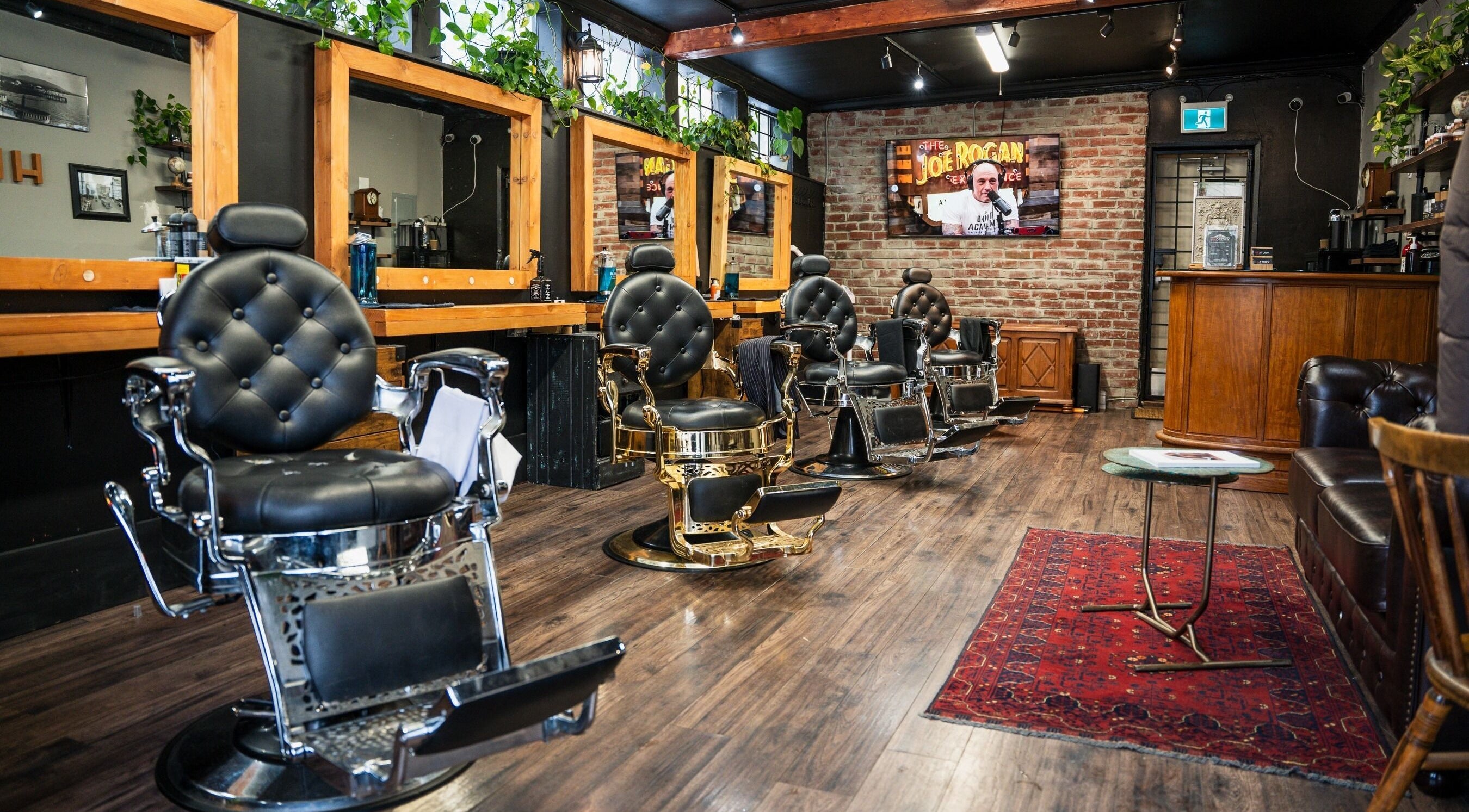 Interior of HEstory Barbershop in Vancouver, BC, showcasing vintage barber chairs and rustic decor.