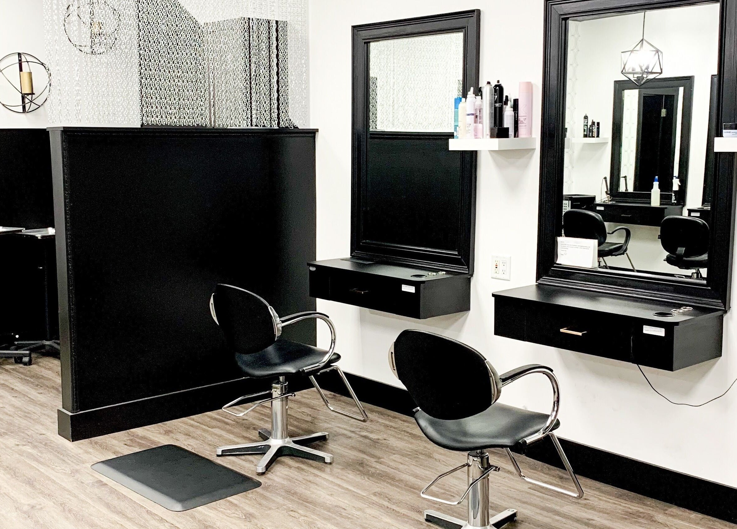 Modern salon setup at Contagious Studio in Abbotsford, British Columbia, CA with stylish black chairs and mirrors.
