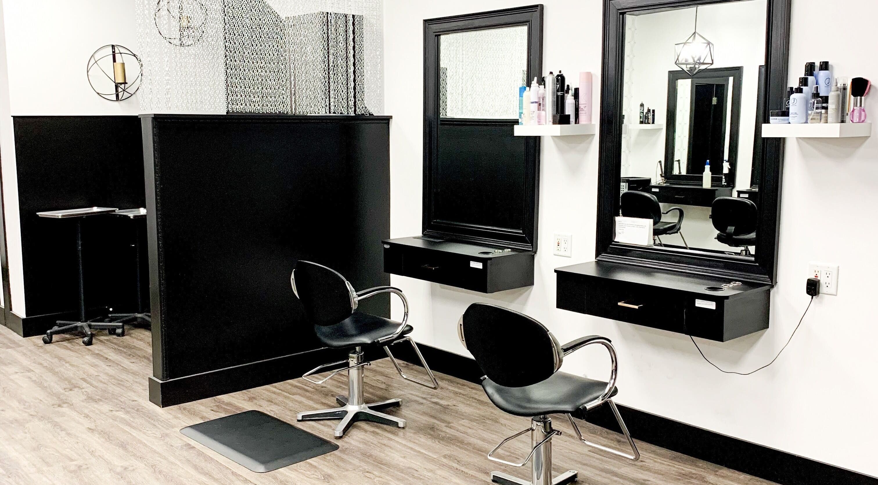 Modern salon setup at Contagious Studio in Abbotsford, British Columbia, CA with stylish black chairs and mirrors.