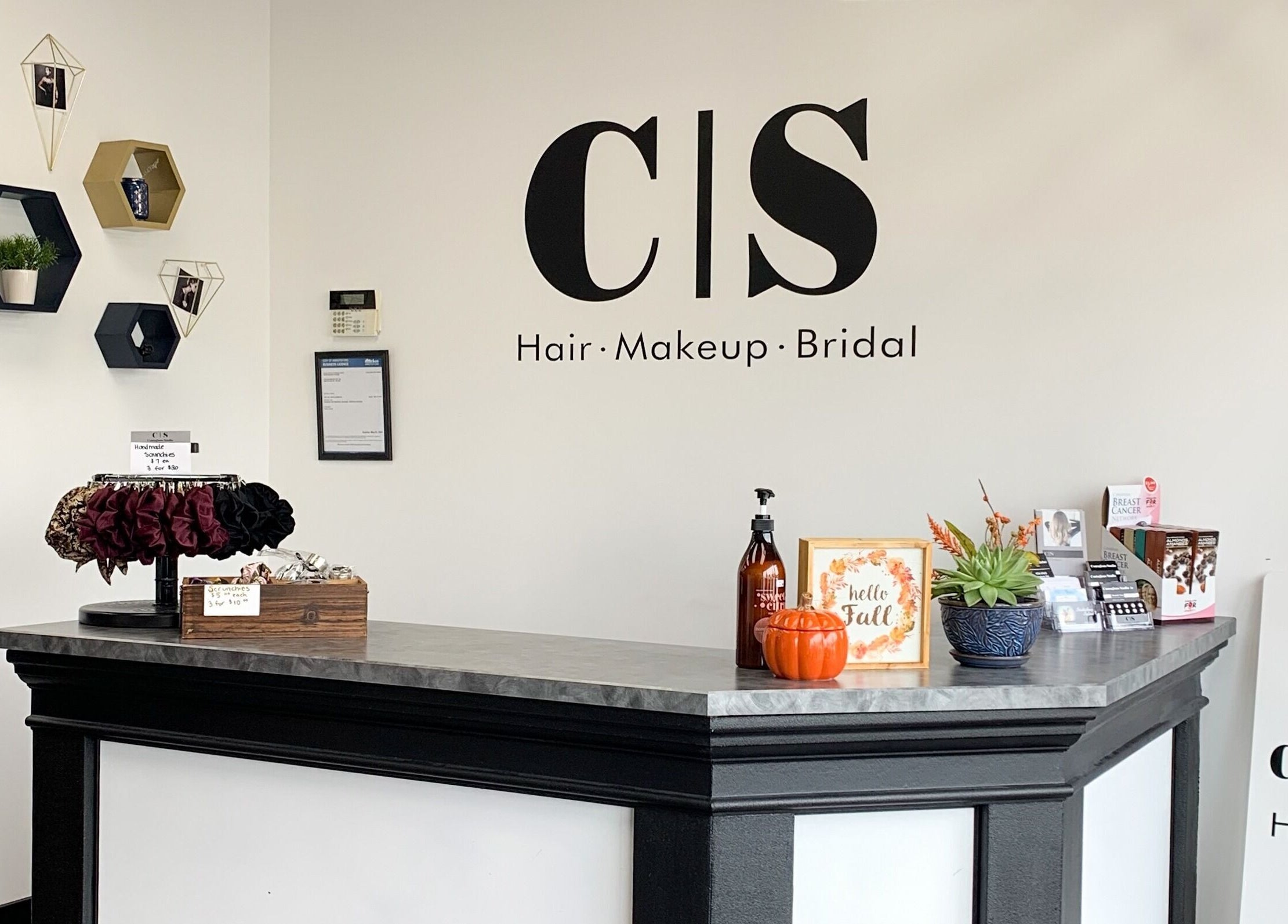 Reception desk at Contagious Studio, Abbotsford, BC, CA with elegant wall decor and a welcoming vibe.