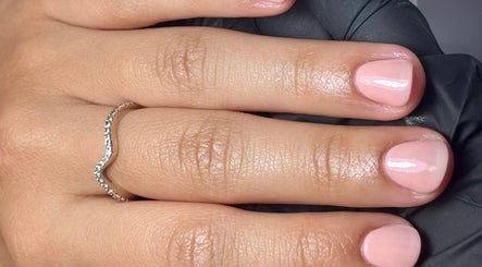 Close-up of manicured pink nails with a ring at Sophie Victoria Nails, Frome, England, GB.