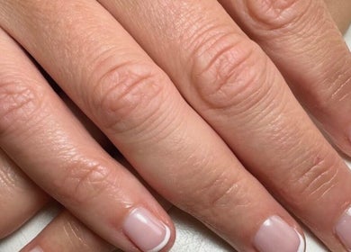 Close-up of a French manicure at Sophie Victoria Nails, Frome, England, GB, showcasing elegant nail art.