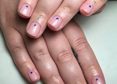 Stylish nail art at Sophie Victoria Nails, Frome, England, GB showing minimalist blue dot design.