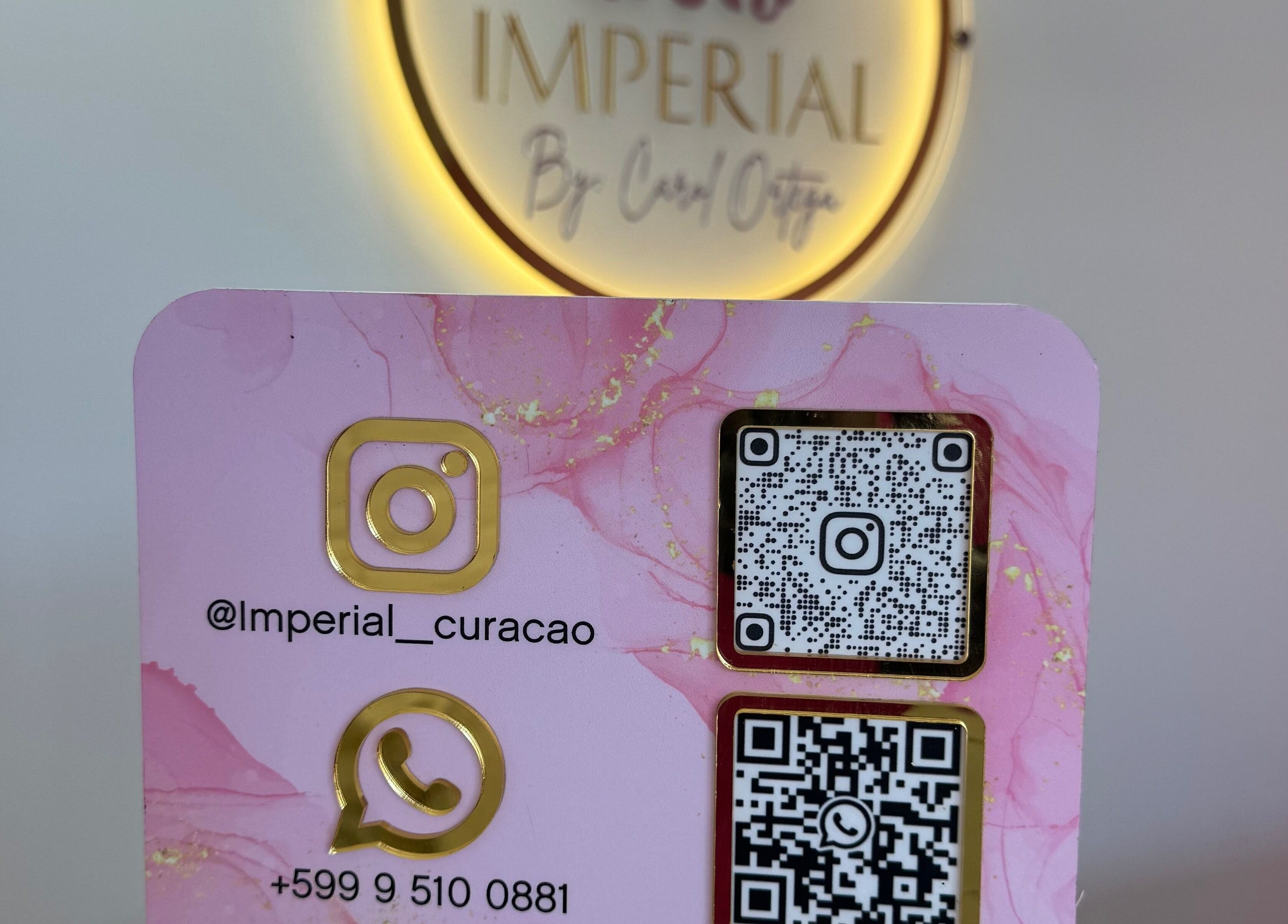 Contact card at Imperial Curacao in Willemstad, Curaçao featuring WhatsApp and Instagram QR codes.