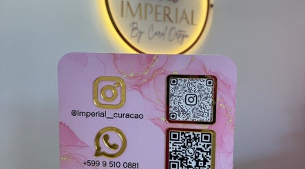Contact card at Imperial Curacao in Willemstad, Curaçao featuring WhatsApp and Instagram QR codes.