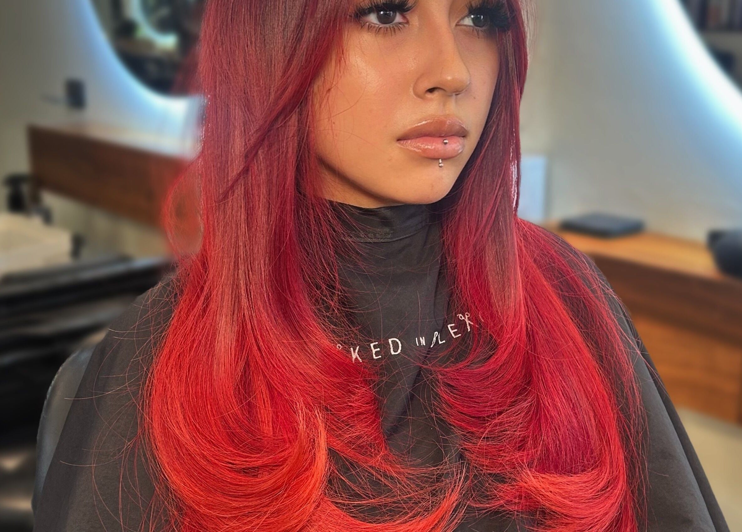 Client with vibrant red hair styled at Styled By Elicia, West Covina, California, US salon.