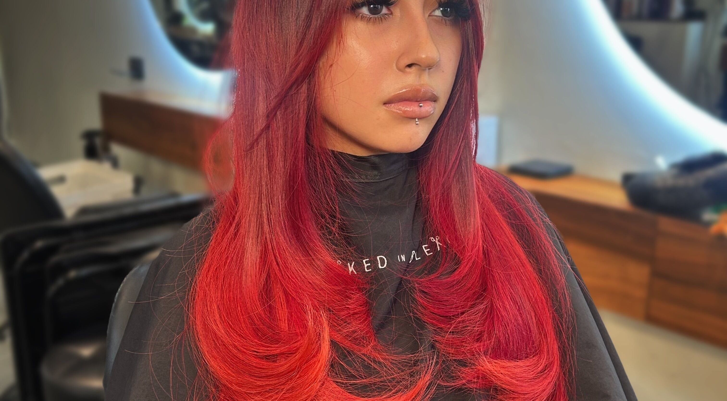 Client with vibrant red hair styled at Styled By Elicia, West Covina, California, US salon.