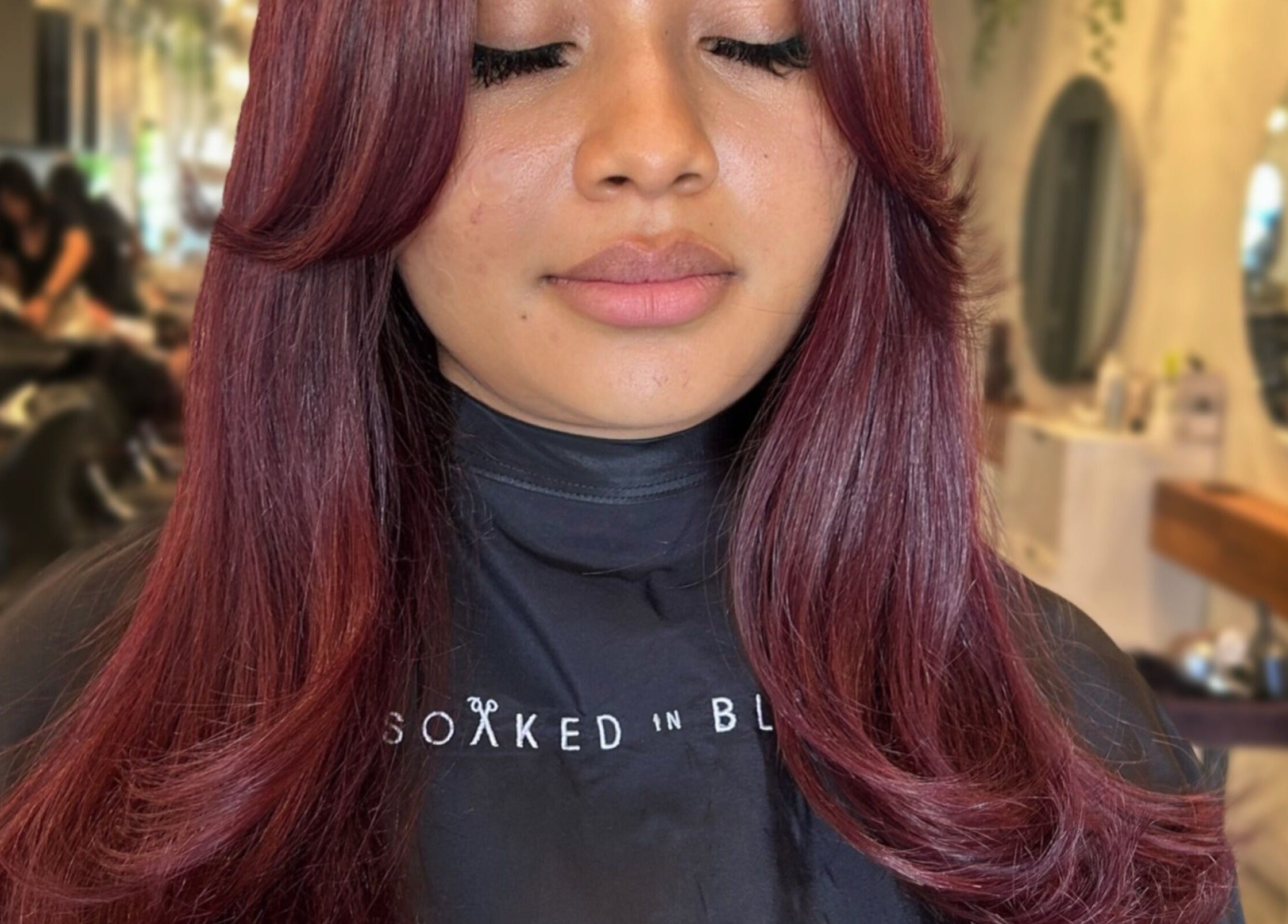 Rich, ruby-red hair styled beautifully at Styled By Elicia in West Covina, California, US. Elegant hair salon.