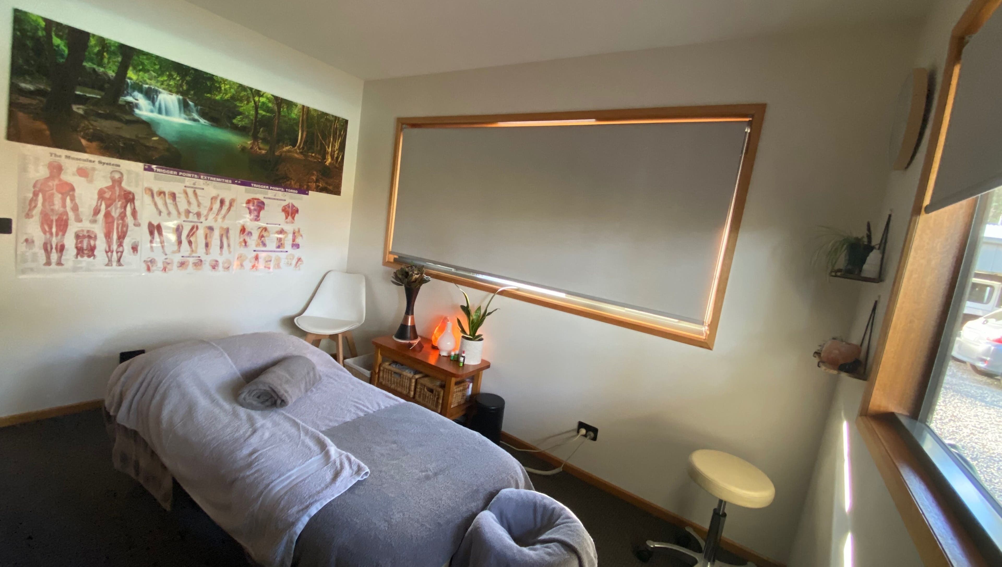 Peaceful massage room at Relax & Bloom, Kettering, Tasmania, AU, featuring serene decor and comfortable treatment bed.