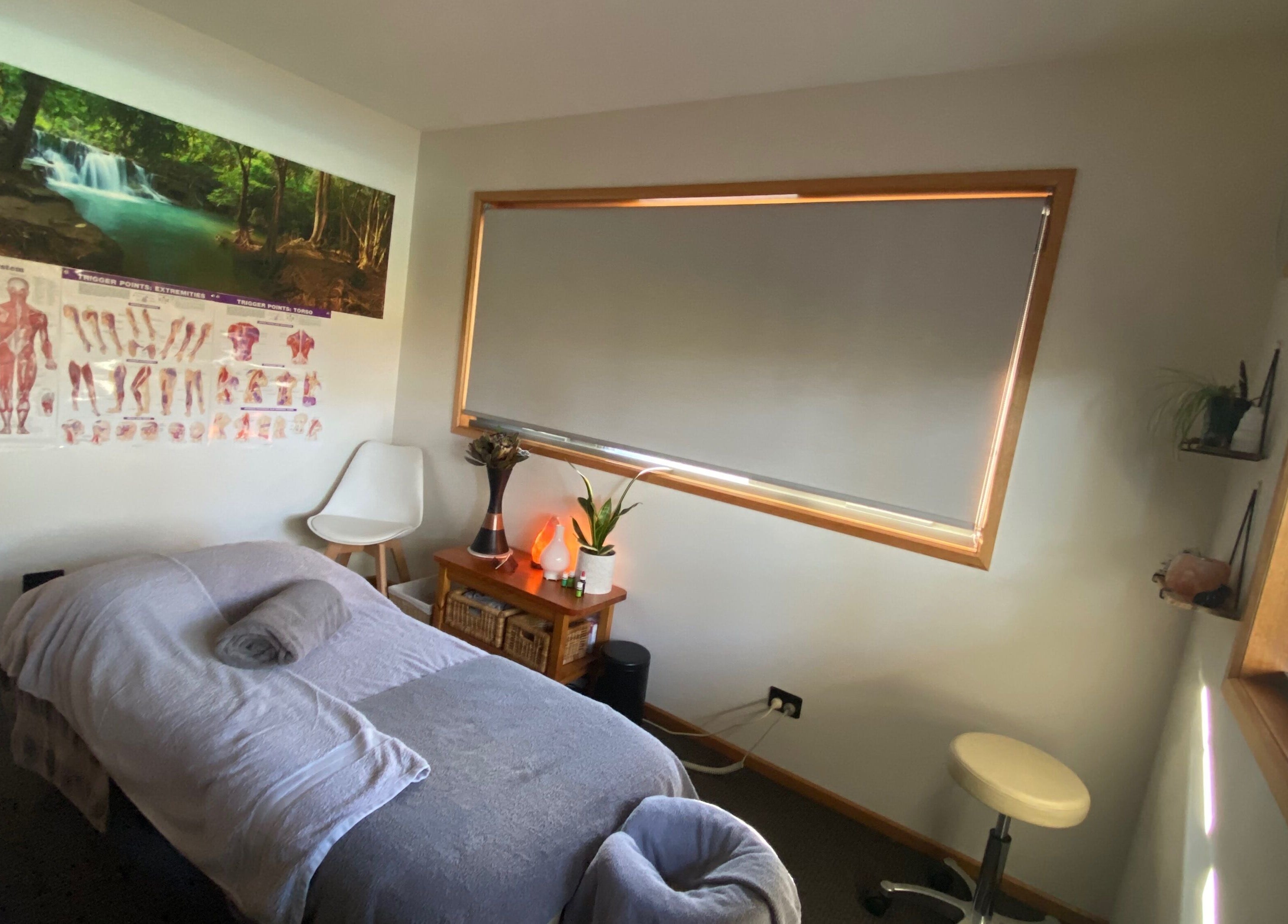Peaceful massage room at Relax & Bloom, Kettering, Tasmania, AU, featuring serene decor and comfortable treatment bed.