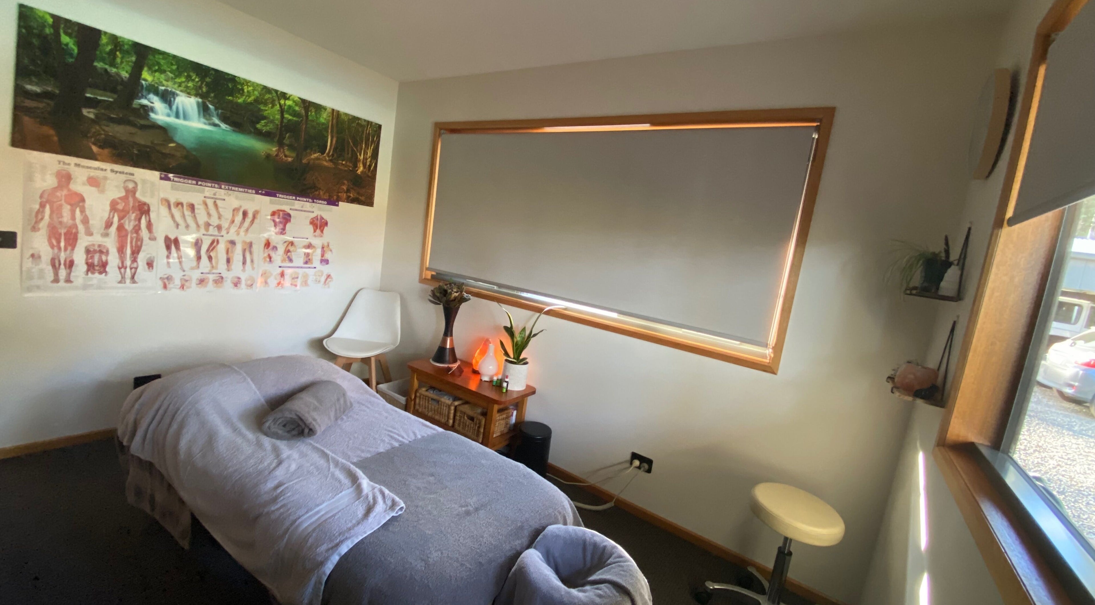 Peaceful massage room at Relax & Bloom, Kettering, Tasmania, AU, featuring serene decor and comfortable treatment bed.