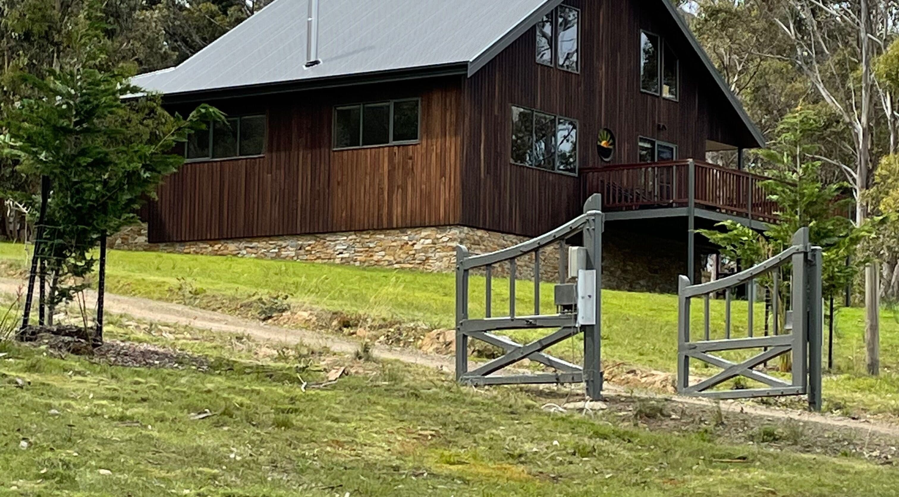 Charming wooden venue Relax & Bloom in Kettering, Tasmania, AU, amid lush greenery and tranquil surroundings.