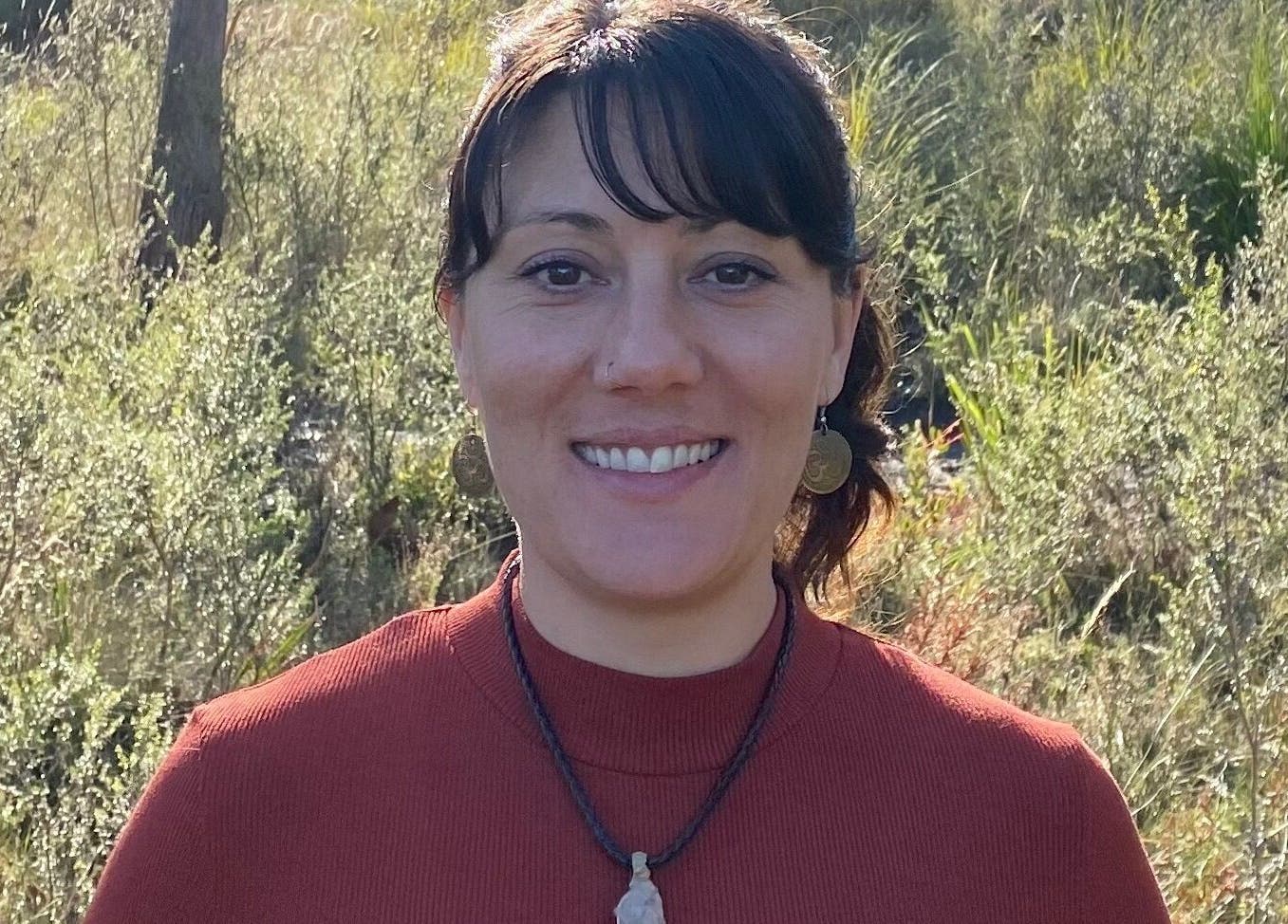 Woman smiling in nature at Relax & Bloom, Kettering, Tasmania, AU.