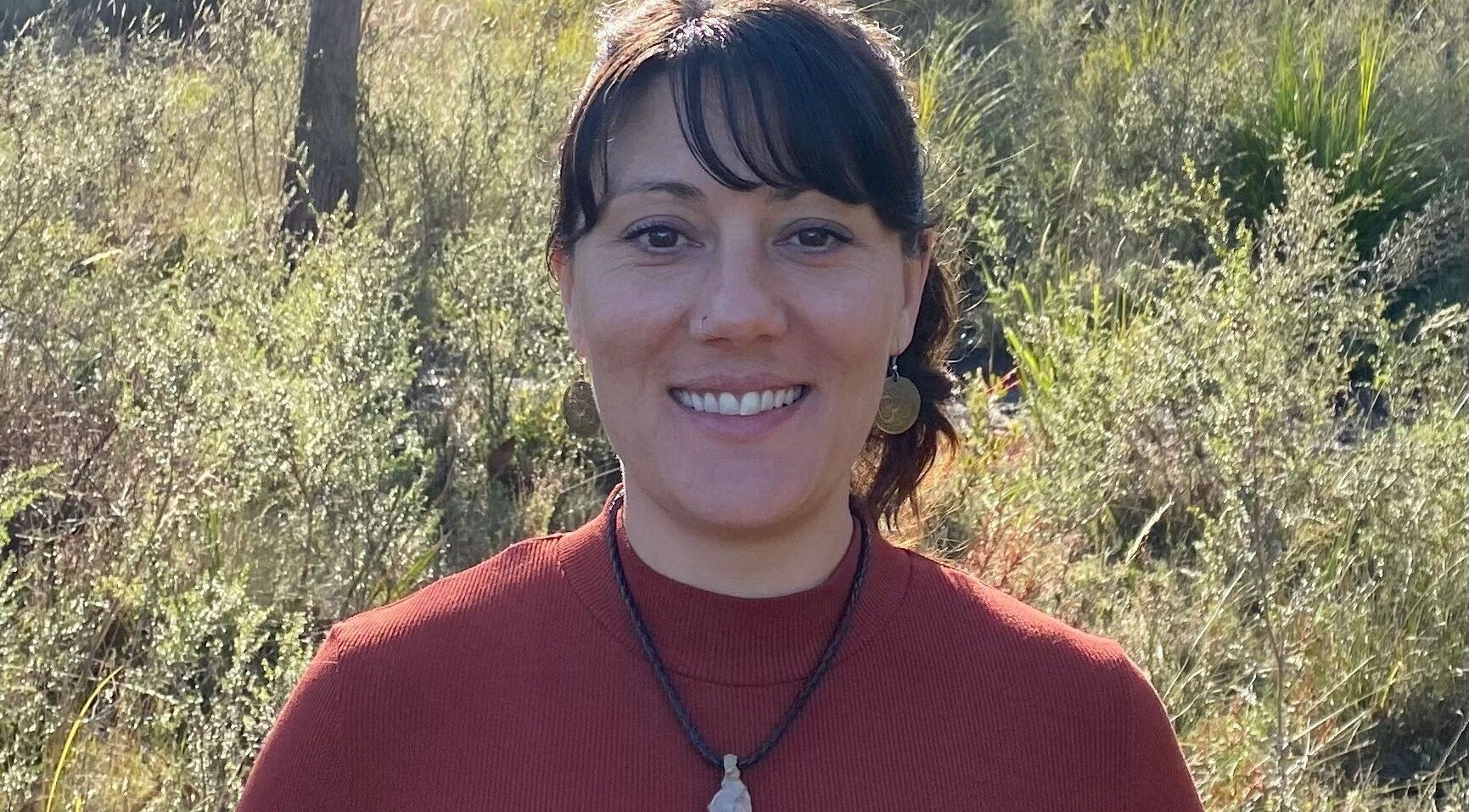 Woman smiling in nature at Relax & Bloom, Kettering, Tasmania, AU.