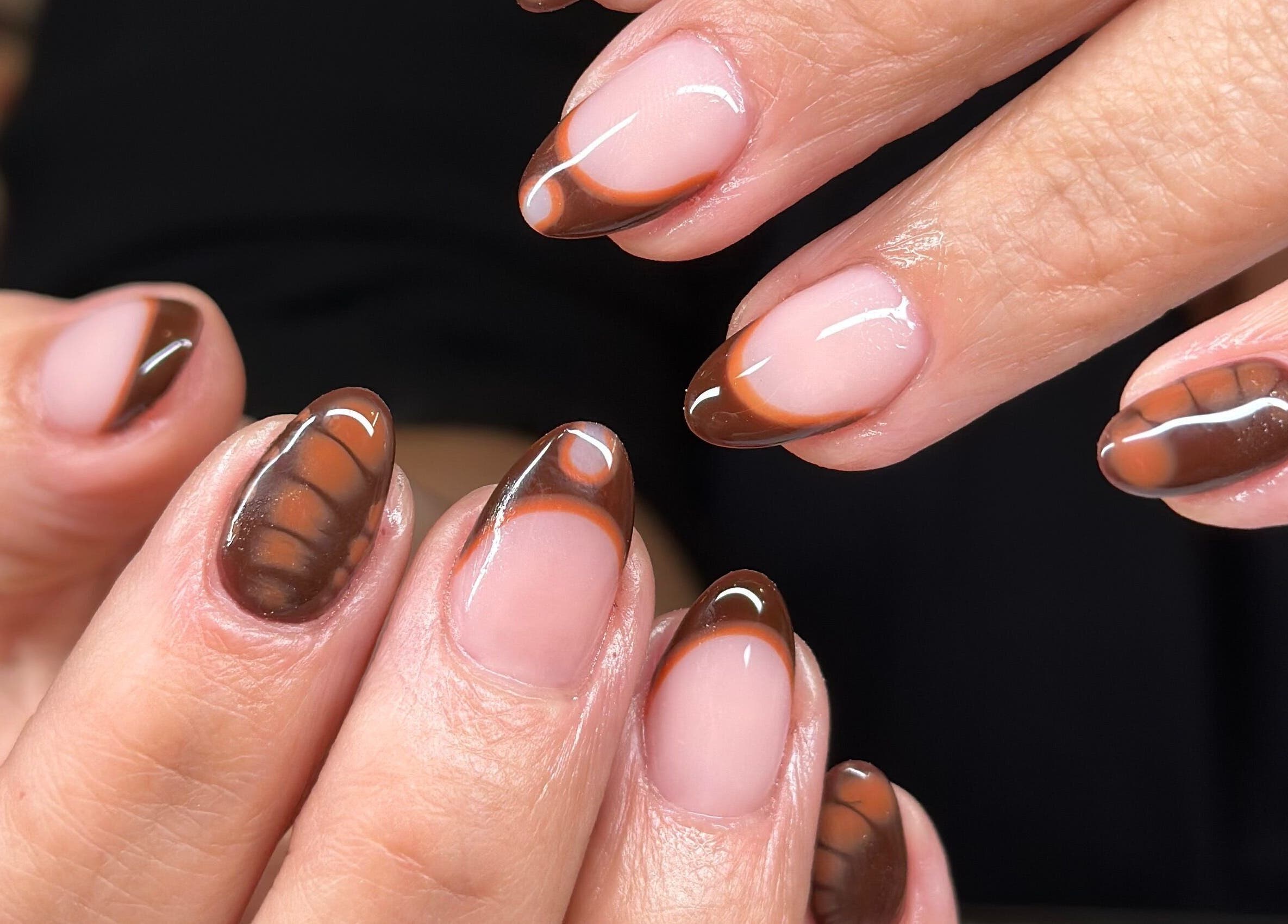 Elegant chocolate-themed nail art at Ongles Alessandra, Montréal, Québec, CA, showcasing glossy finish.