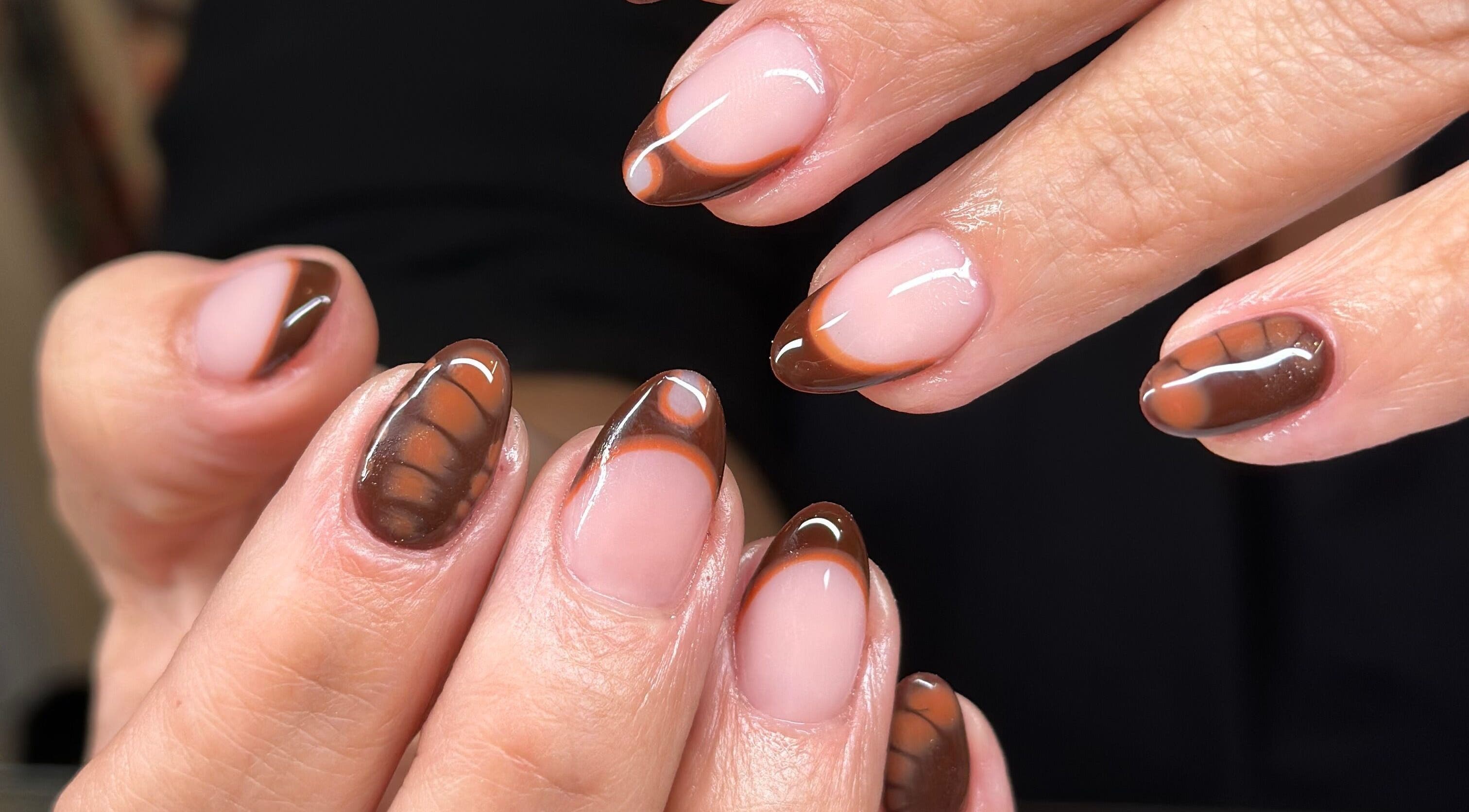 Elegant chocolate-themed nail art at Ongles Alessandra, Montréal, Québec, CA, showcasing glossy finish.