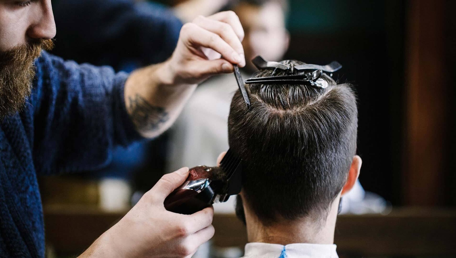 Professional haircutting at Craft Education, Novi, Michigan, US. Detailed close-up of skilled grooming.