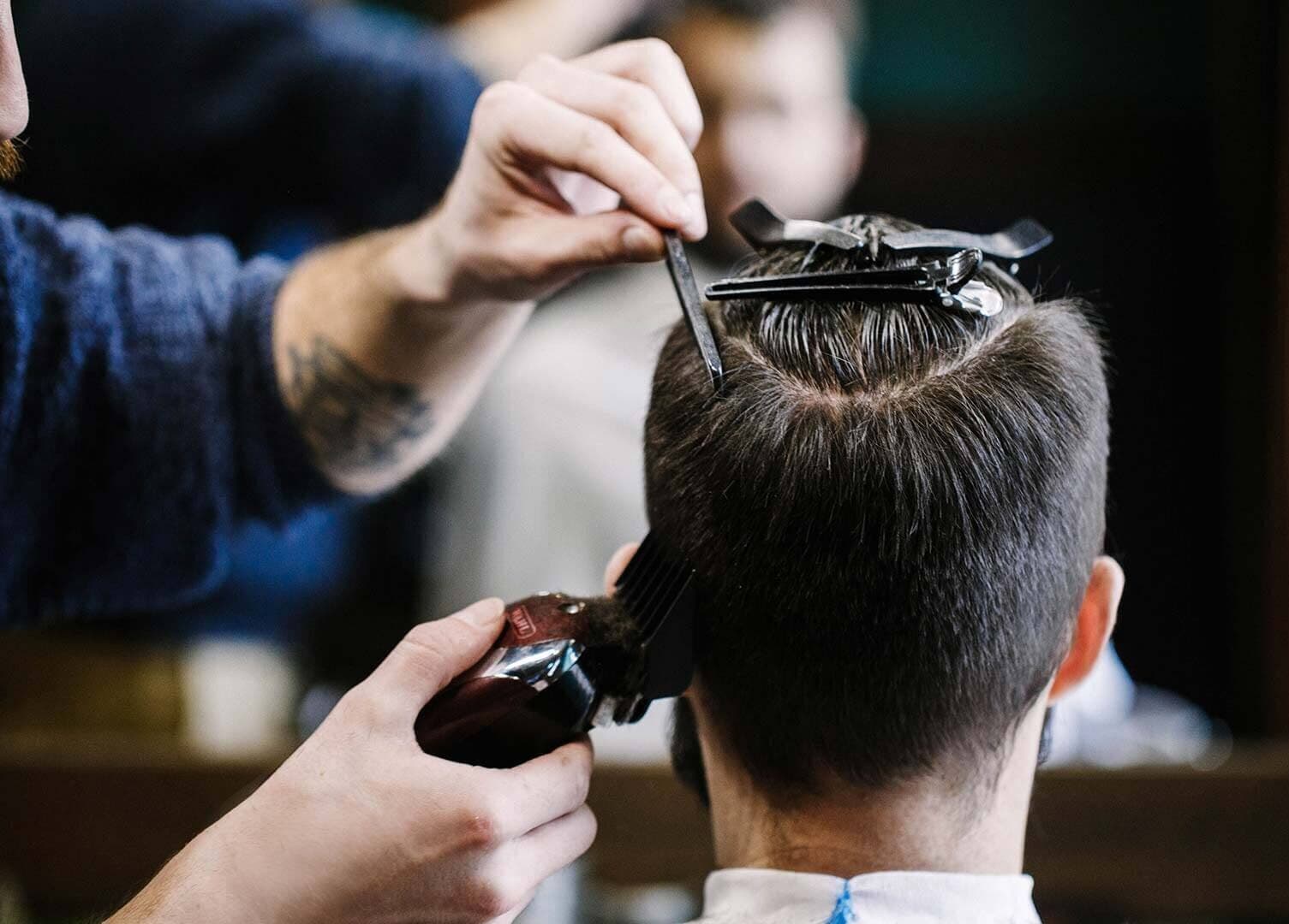 Professional haircutting at Craft Education, Novi, Michigan, US. Detailed close-up of skilled grooming.