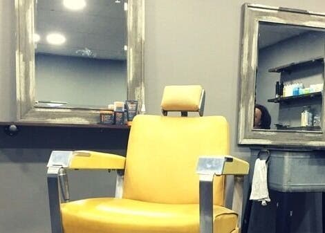 Modern barber chair at Craft Education in Novi, Michigan, US, with mirrors and styling tools displayed.