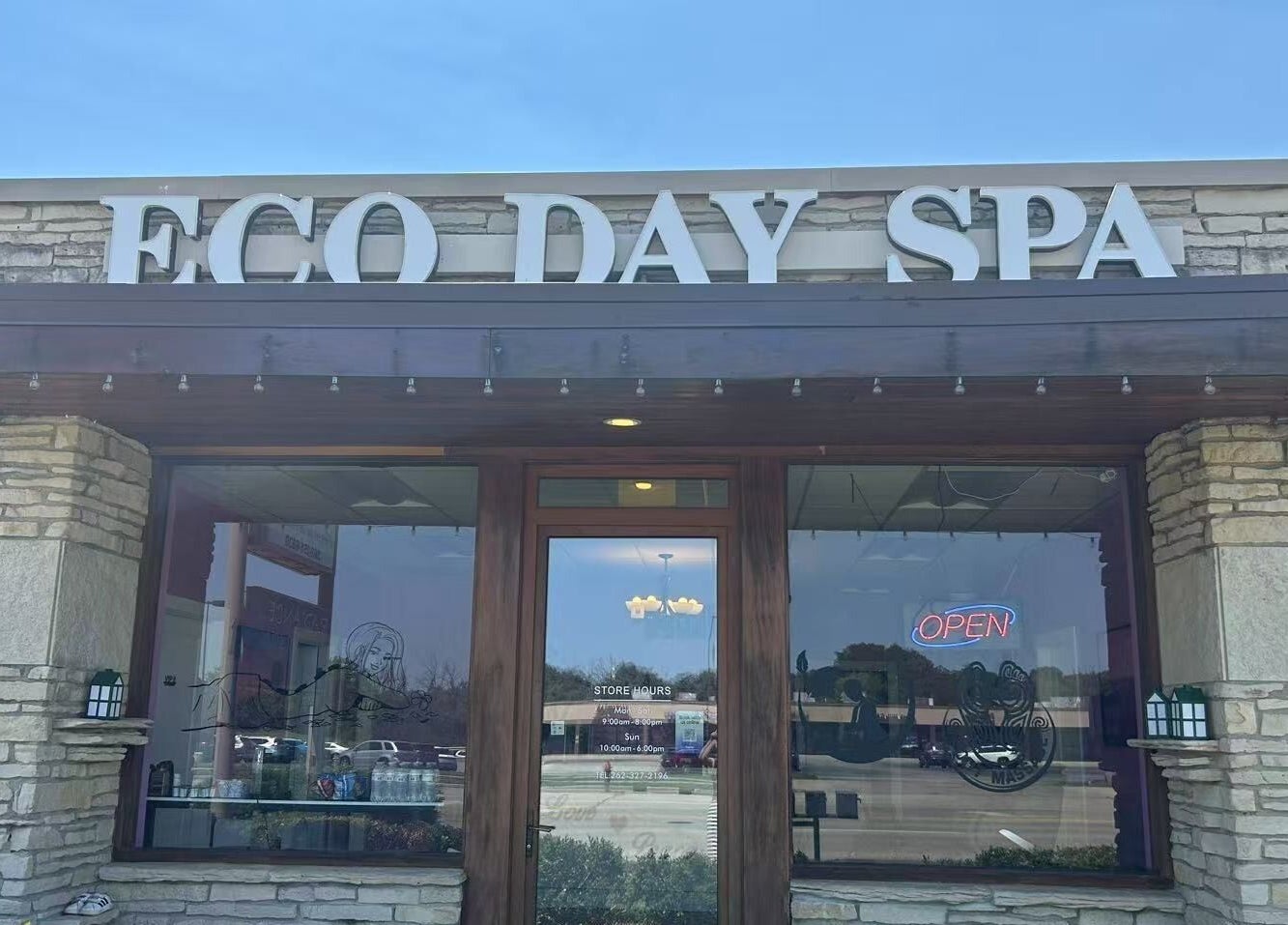 Front view of ECO Day Spa in Menomonee Falls, Wisconsin, US, showcasing its inviting stone facade.