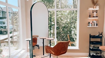 Bright salon at Elleven Hair Studio, Langley Township, CA, showcasing chic styling chair and modern decor.