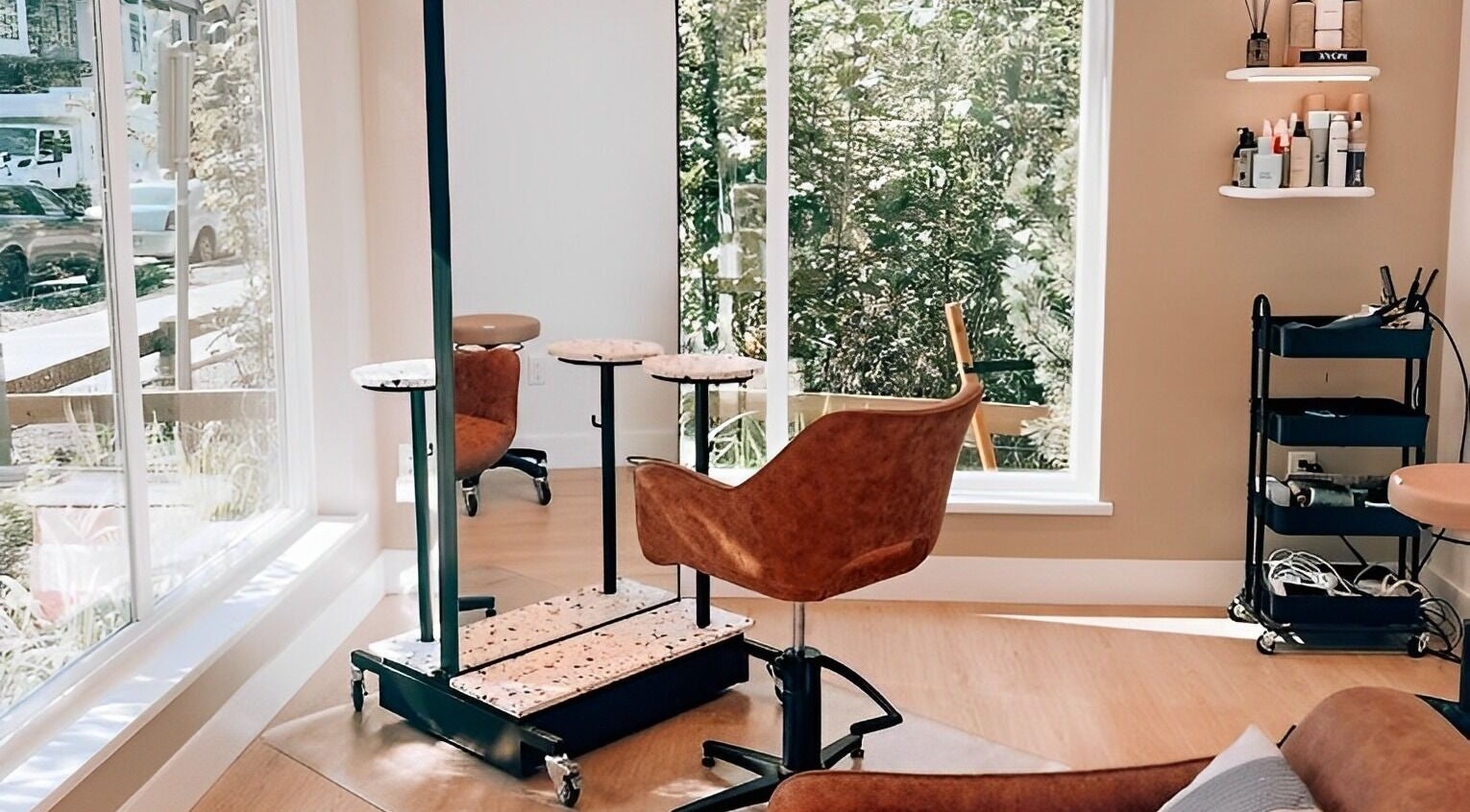 Elleven Hair Studio's bright and cozy interior in Langley Township, CA, featuring a stylish chair and beauty products.