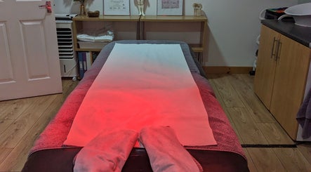 Calm massage room at Level up Massage, Fareham, England, GB with treatment table and warm lighting.