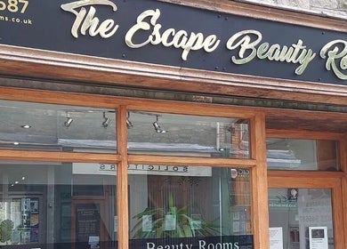 Front entrance of The Escape Beauty Rooms and SCP Therapy in Abertillery, Wales, GB, showcasing modern signage.