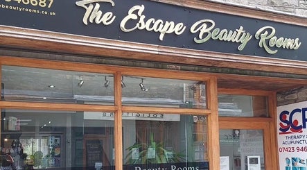 Front entrance of The Escape Beauty Rooms and SCP Therapy in Abertillery, Wales, GB, showcasing modern signage.