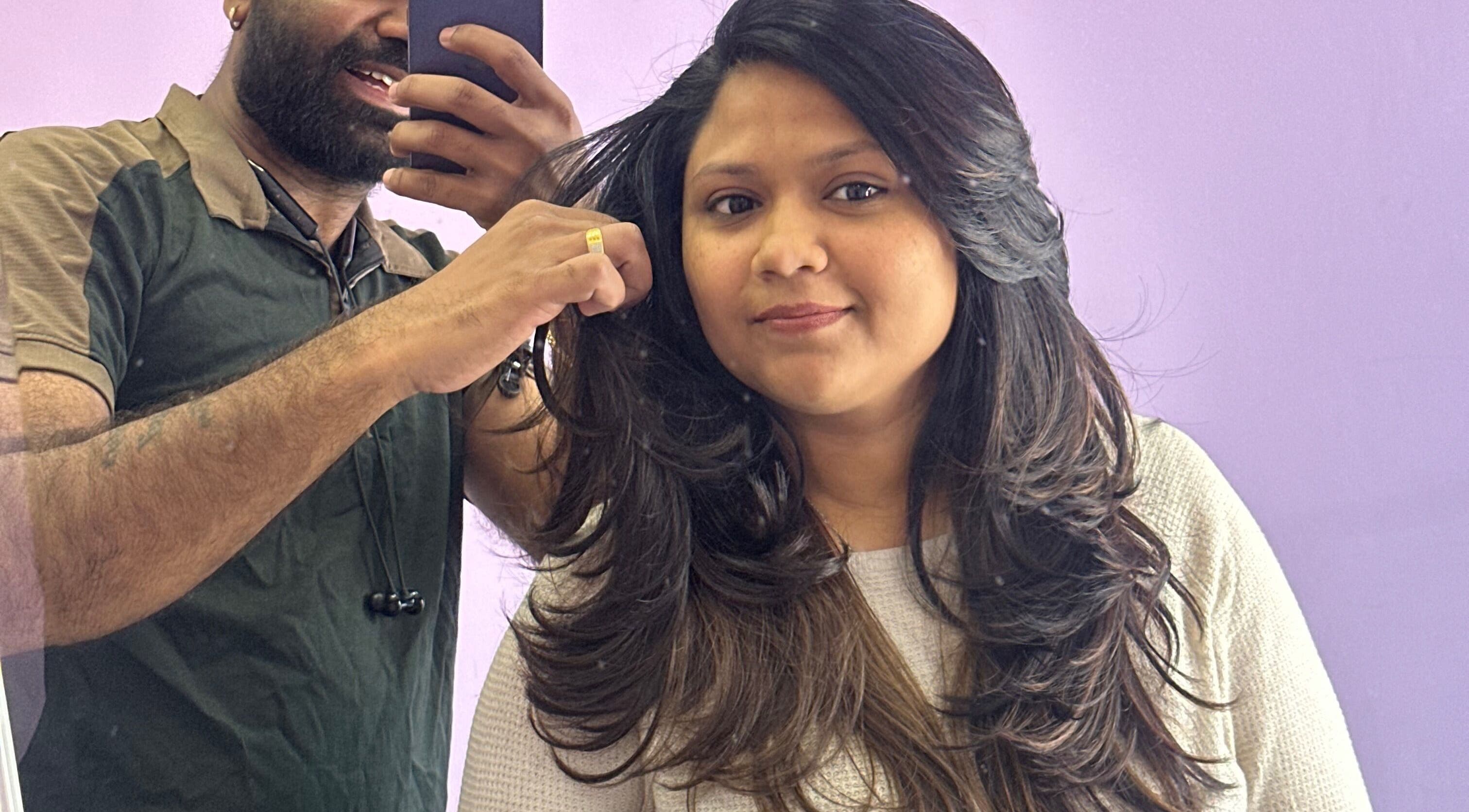 Professional hairstyling at MITS HAIR & BEAUTY, Harrow, England, GB. A stylist skillfully working on a client's hair.