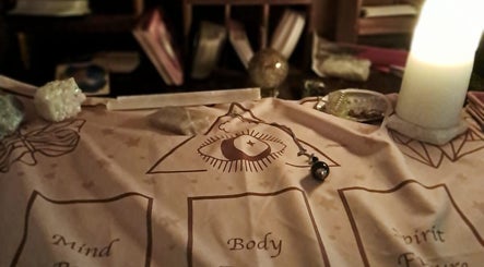 Candlelit spiritual setup at SpiritualMessagesCC, Glasgow, United Kingdom, GB, featuring mystical symbols and crystals.