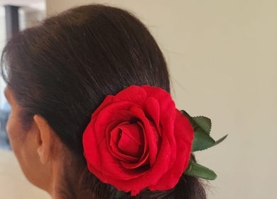 Elegant hairstyle with a red rose at Hair by Sharon @ Boksburg, Gauteng, ZA for a chic look.