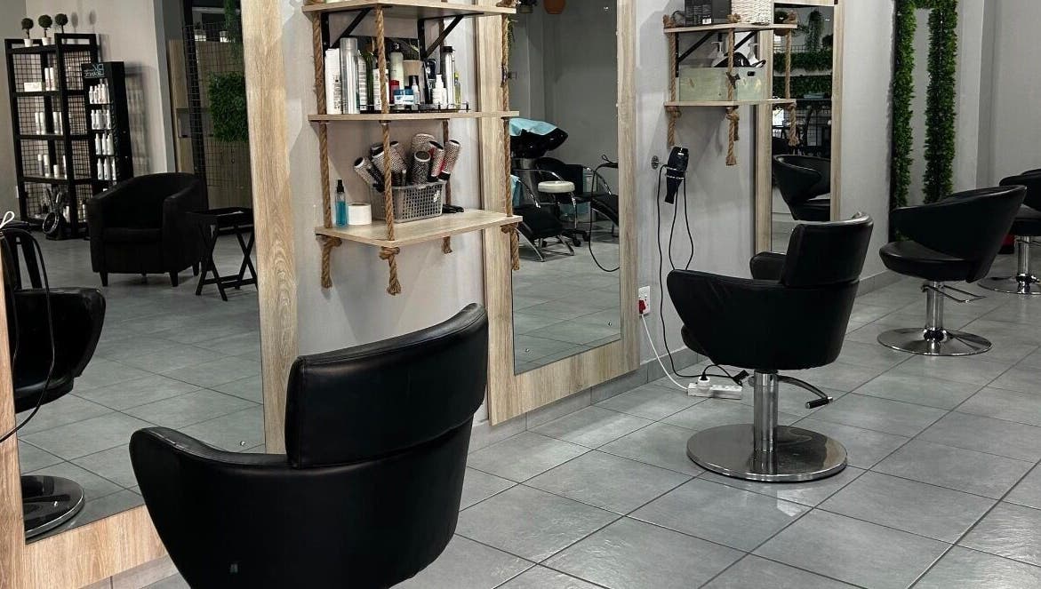 Modern salon interior at Hair by Sharon @ Envy, Boksburg, Gauteng, ZA with stylish black chairs and mirrors.