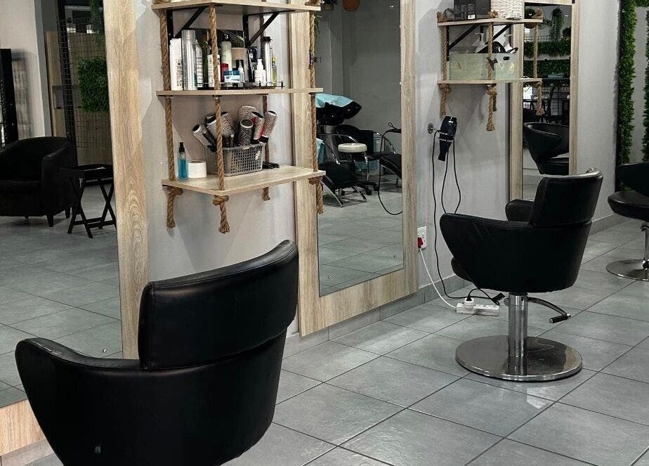 Modern salon interior at Hair by Sharon @ Envy, Boksburg, Gauteng, ZA with stylish black chairs and mirrors.