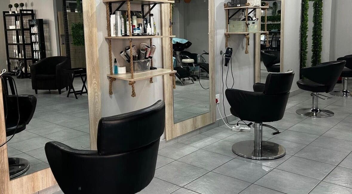 Modern salon interior at Hair by Sharon @ Envy, Boksburg, Gauteng, ZA with stylish black chairs and mirrors.