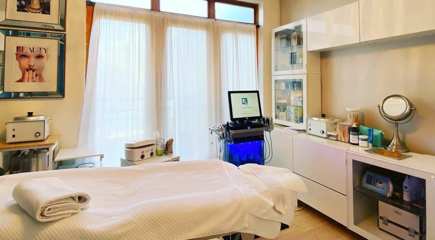 Bright treatment room at Dynamic Salon Spa Studios in Chicago, Illinois, US, featuring a massage table and beauty equipment.