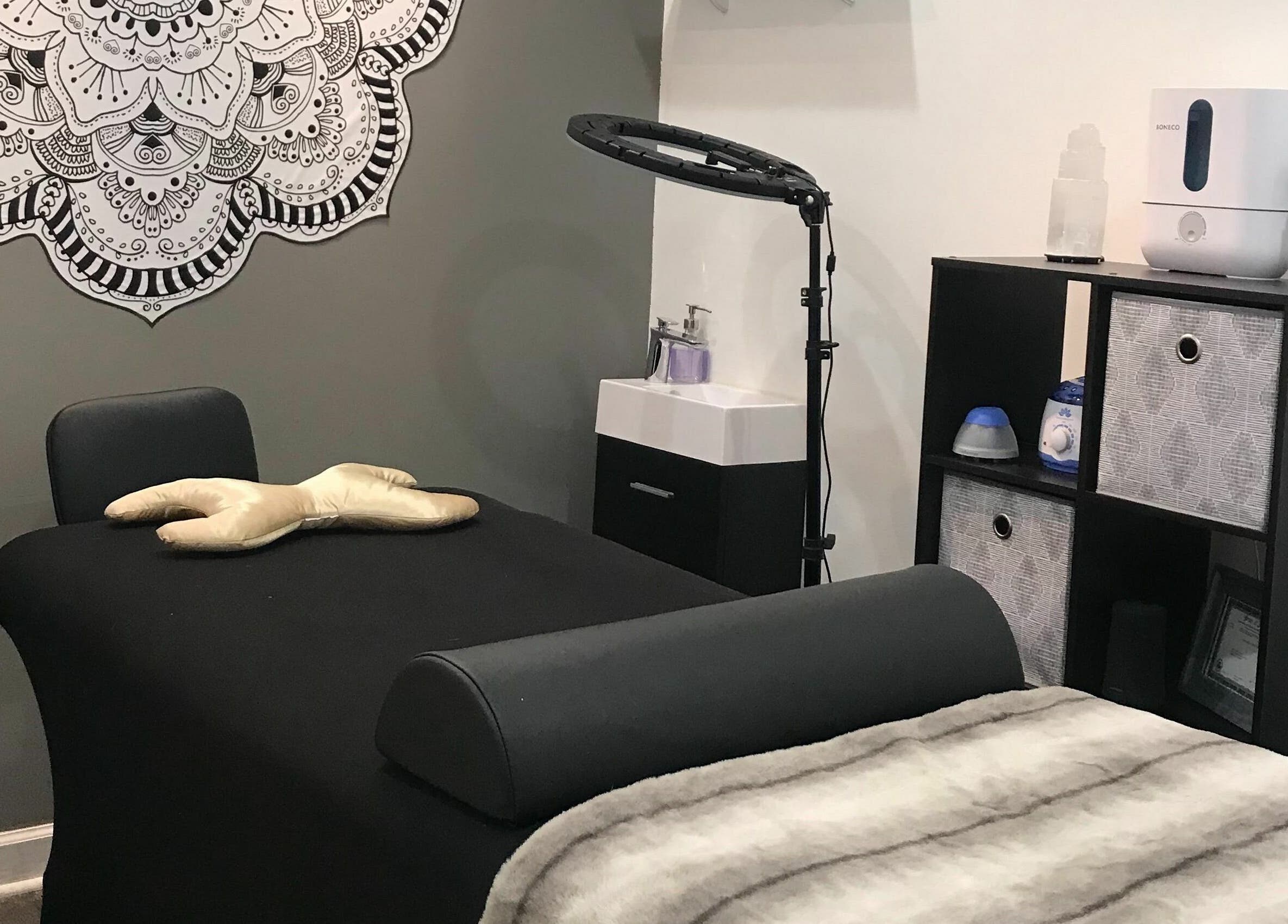 Relaxing massage room at Dynamic Salon Spa Studios in Chicago, Illinois, US with a black massage table and decor.