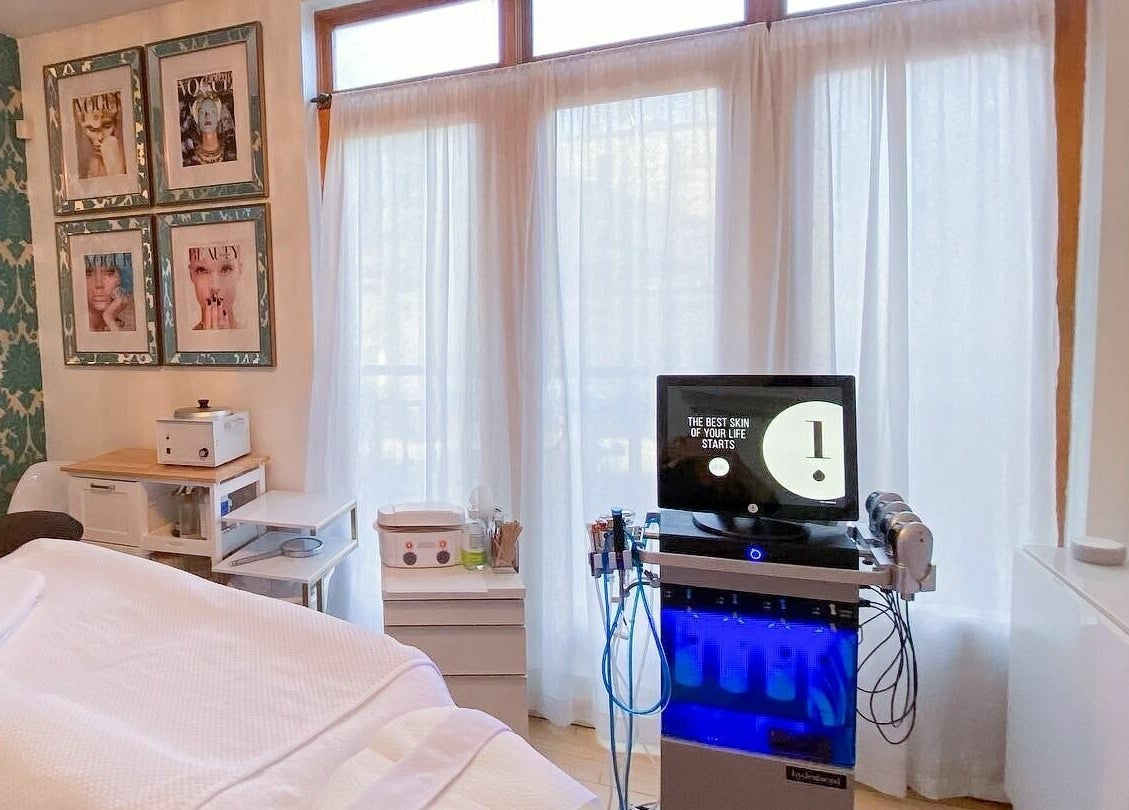 Relaxing treatment room at Dynamic Salon Spa Studios in Chicago, Illinois, US with spa bed and modern equipment.
