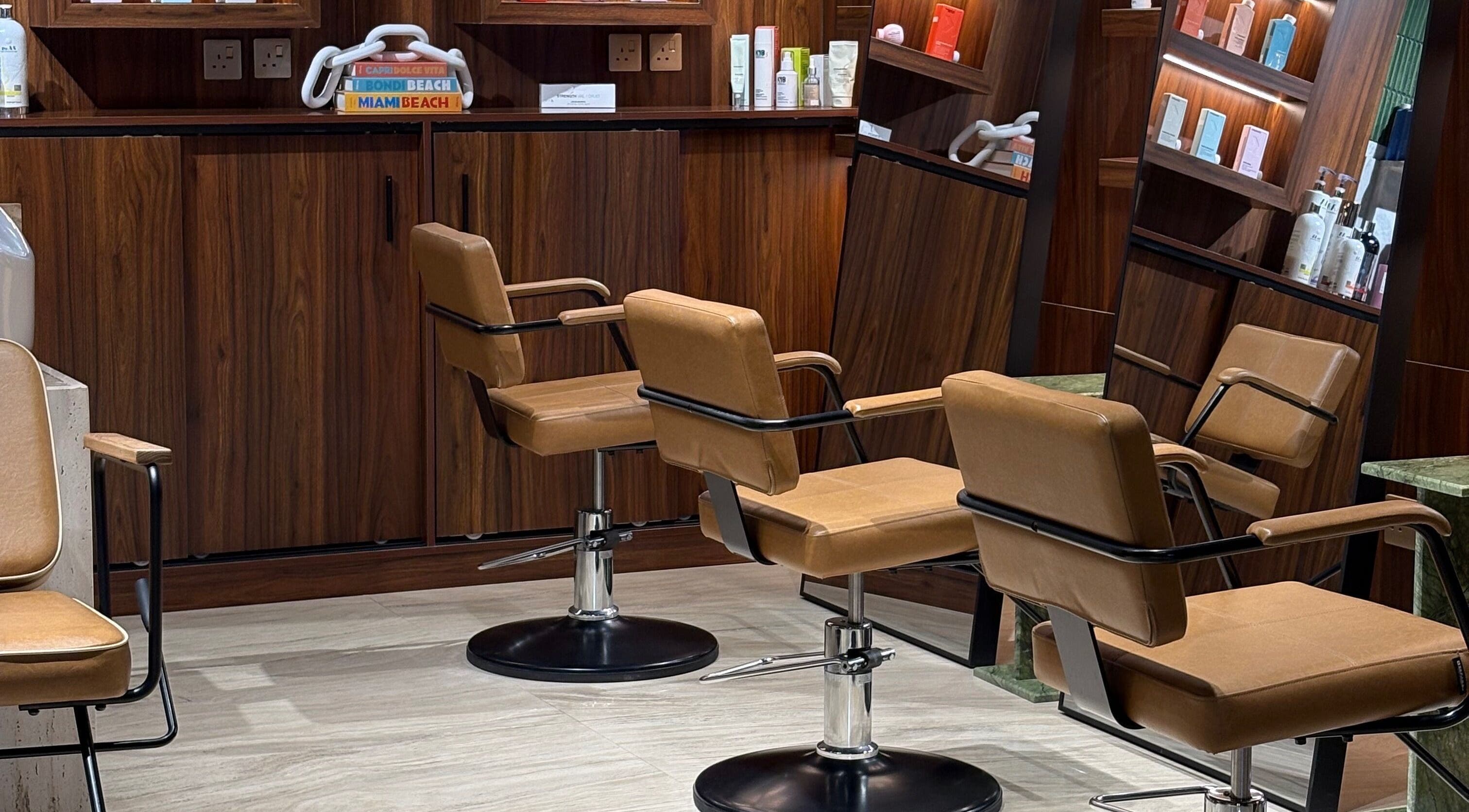 Luxurious salon styling chairs at The Beauty Loft Hair Salon and Spa in Jeddah, SA, offering a premium experience.