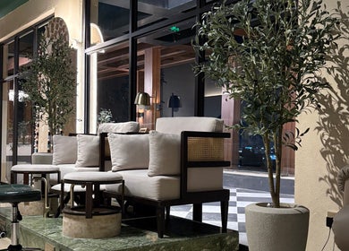 Luxurious seating area at The Beauty Loft Hair Salon and Spa in Jeddah, SA, featuring chic decor and greenery.