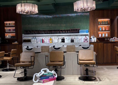 Luxurious interior of The Beauty Loft Hair Salon and Spa in Jeddah, SA with chic seating and product displays.