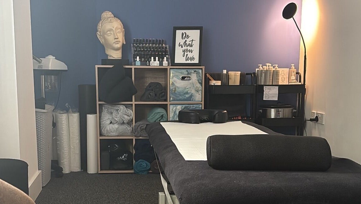 Cozy massage room at The Recovery Room, Suton, England, GB with a serene ambiance and essential oils.