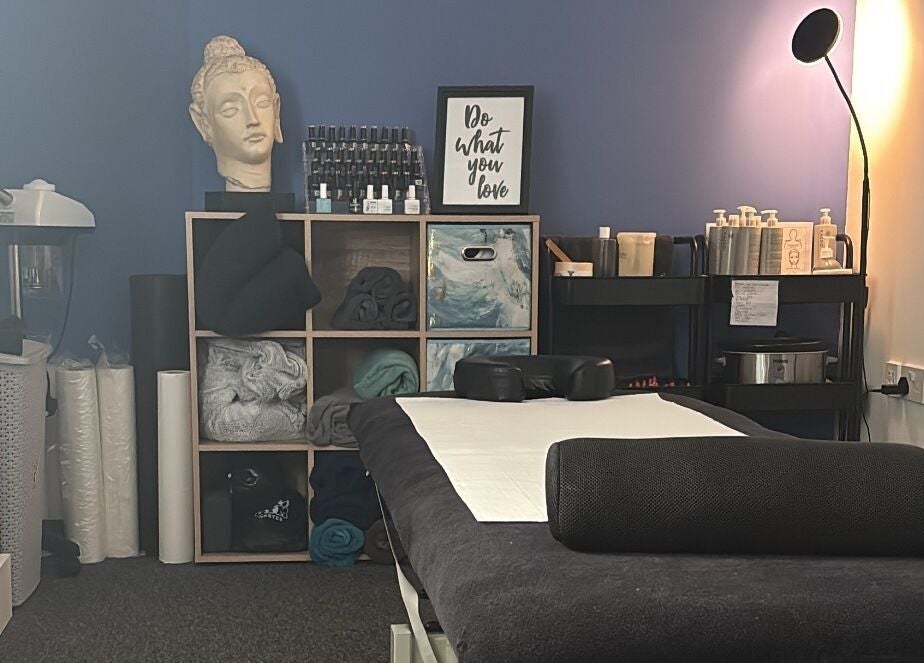 Cozy massage room at The Recovery Room, Suton, England, GB with a serene ambiance and essential oils.