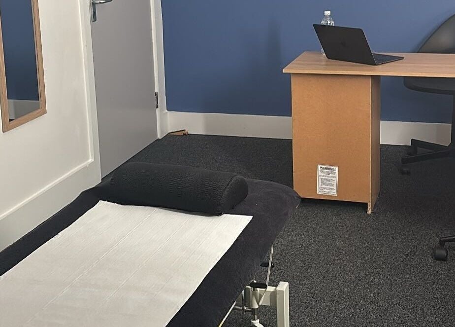 Calming therapy room at The Recovery Room, Suton, England, GB with treatment table and desk.