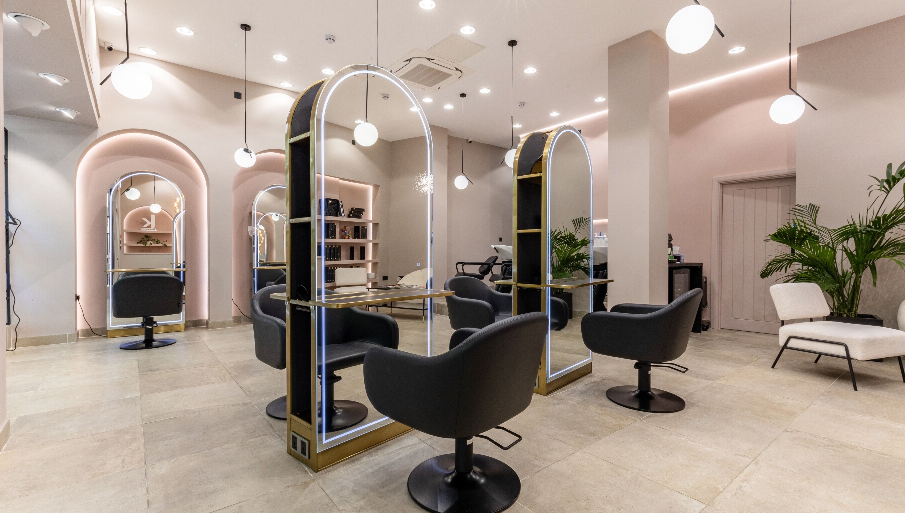 Modern salon interior at Shadi, London, England, GB, featuring stylish chairs and mirrors.