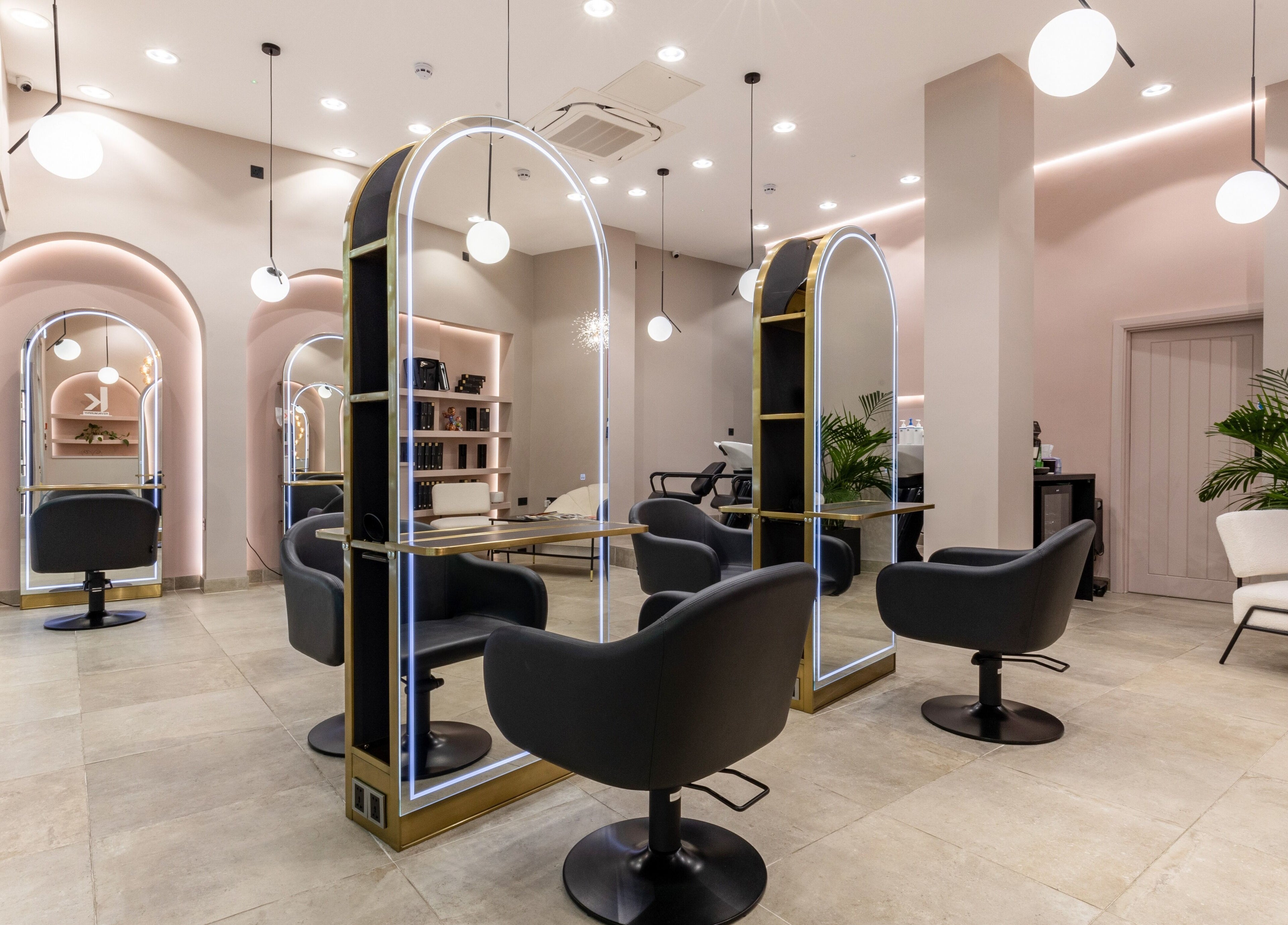Modern salon interior at Shadi, London, England, GB, featuring stylish chairs and mirrors.