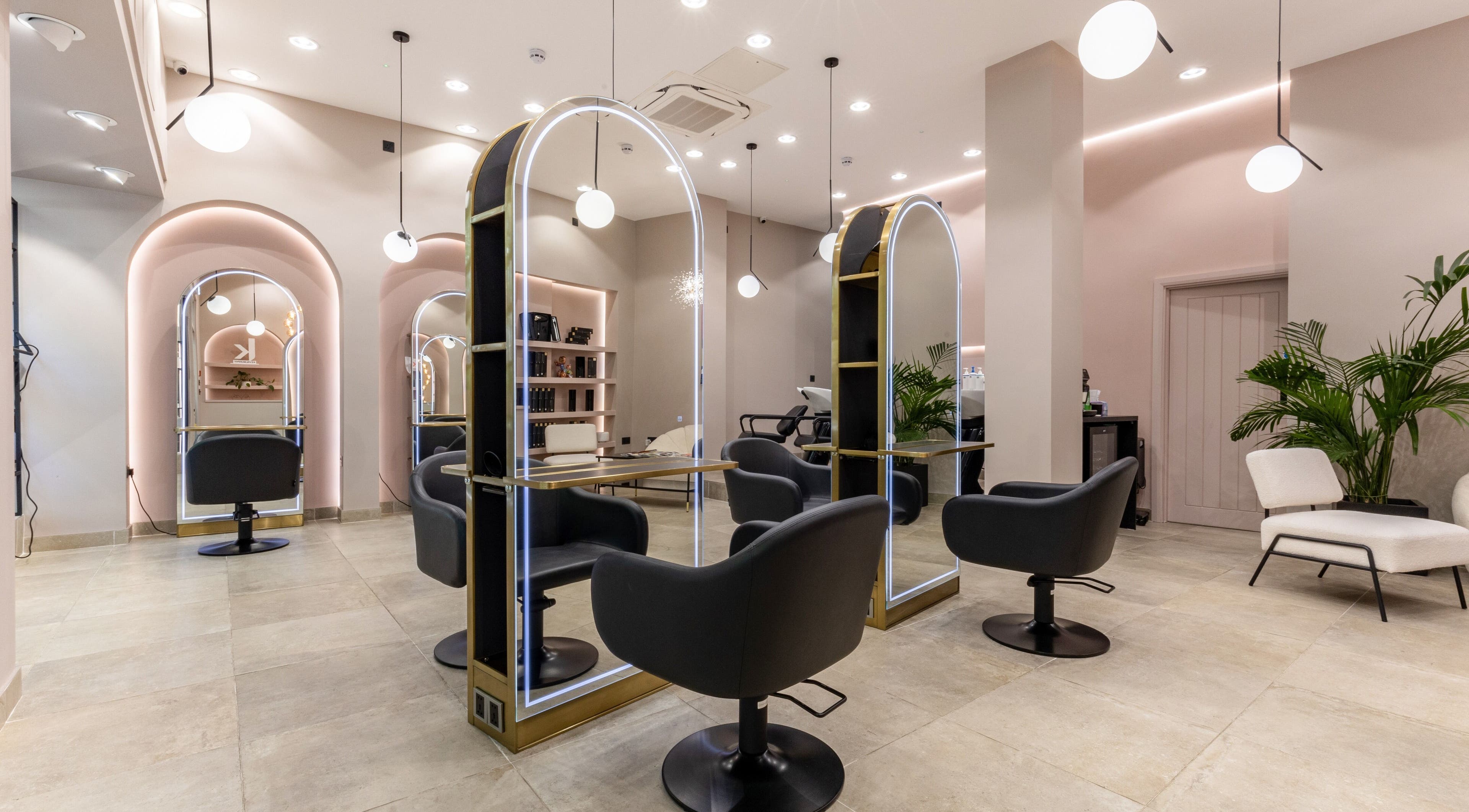 Modern salon interior at Shadi, London, England, GB, featuring stylish chairs and mirrors.